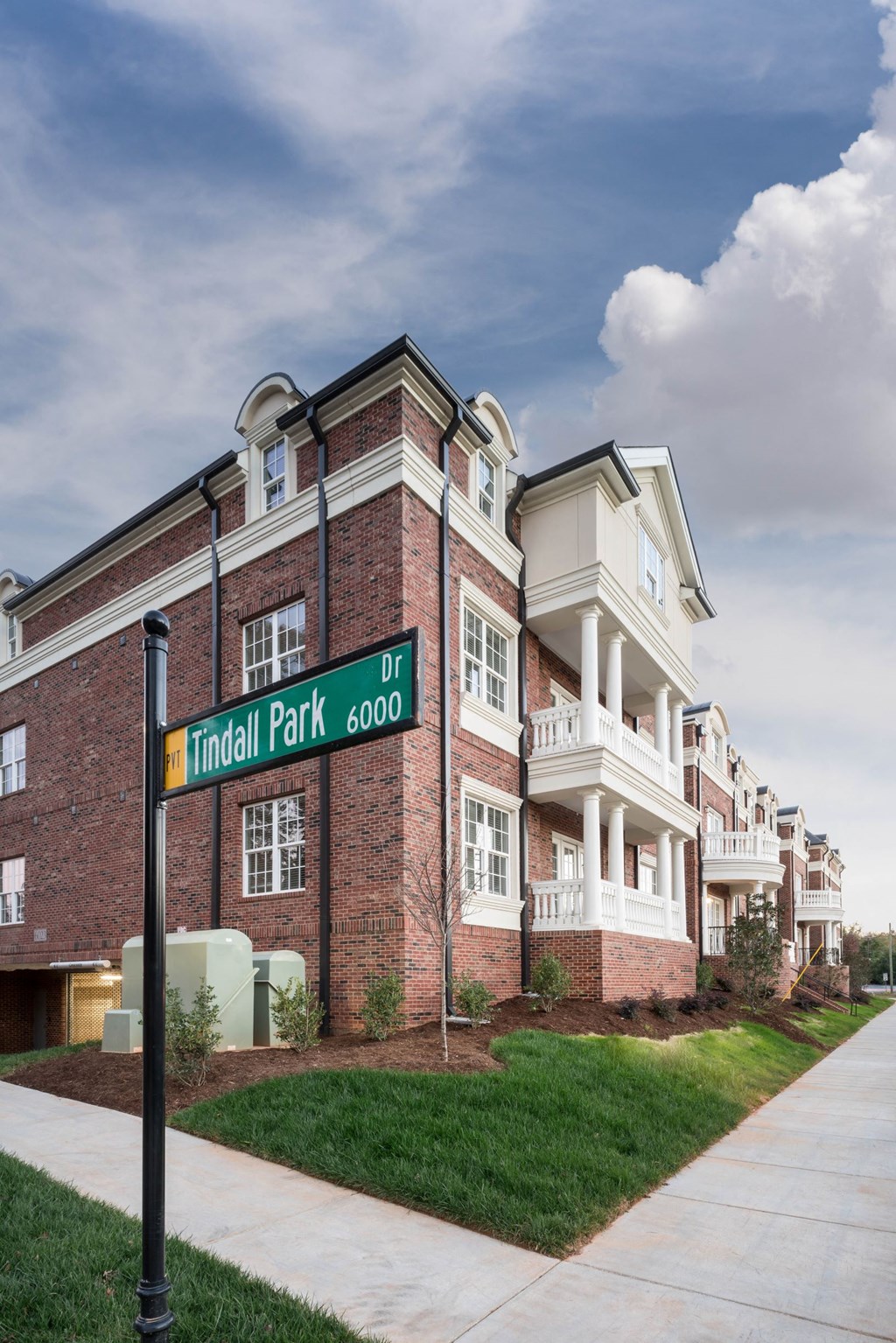 a street sign in front of a brick building