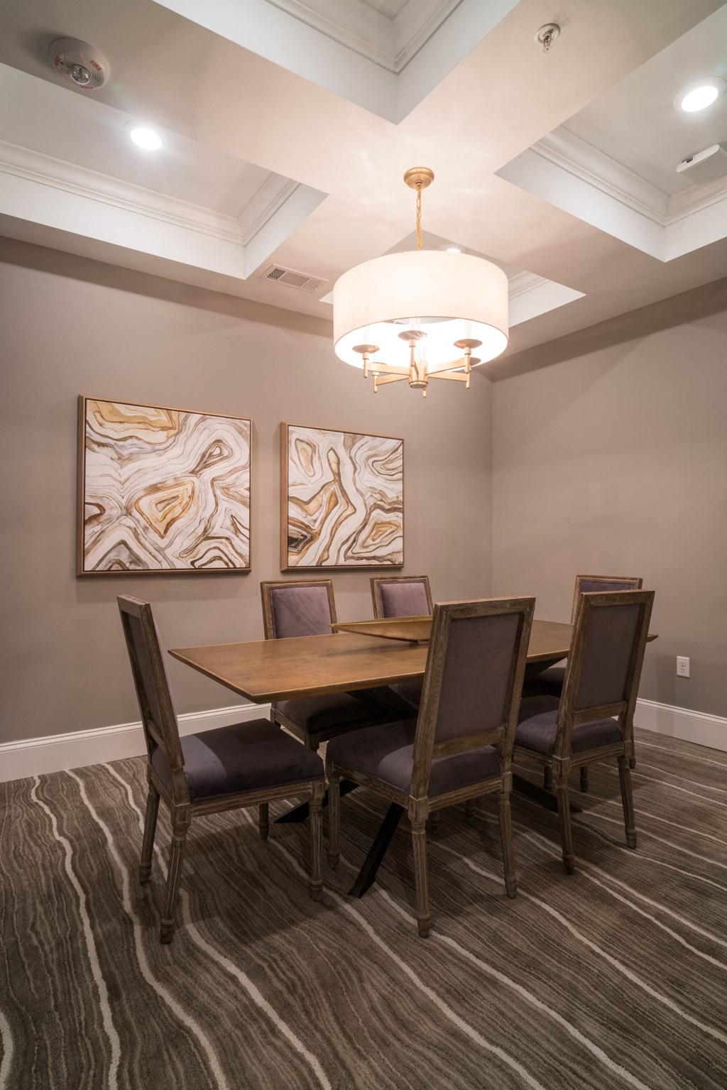 a dining room with a table and chairs under a chandelier