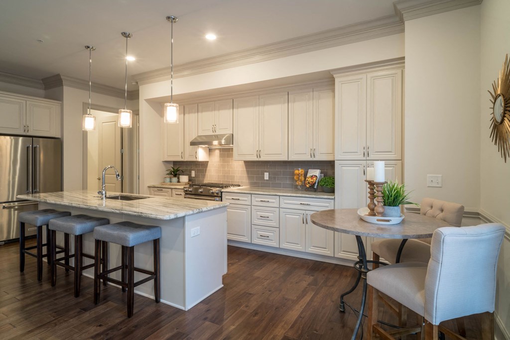 a kitchen with a center island and a bar with stools