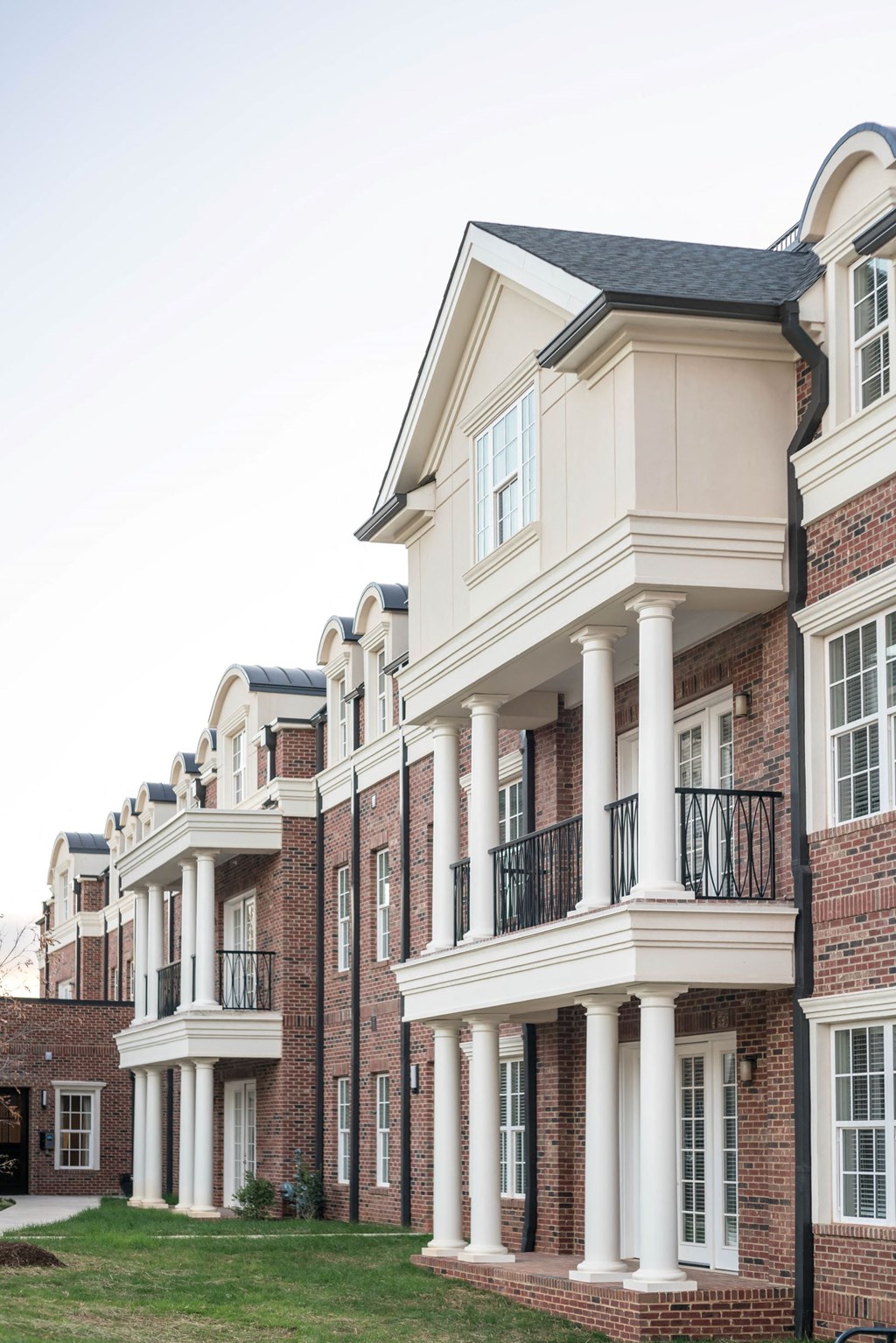 a row of town houses with balconies and columns