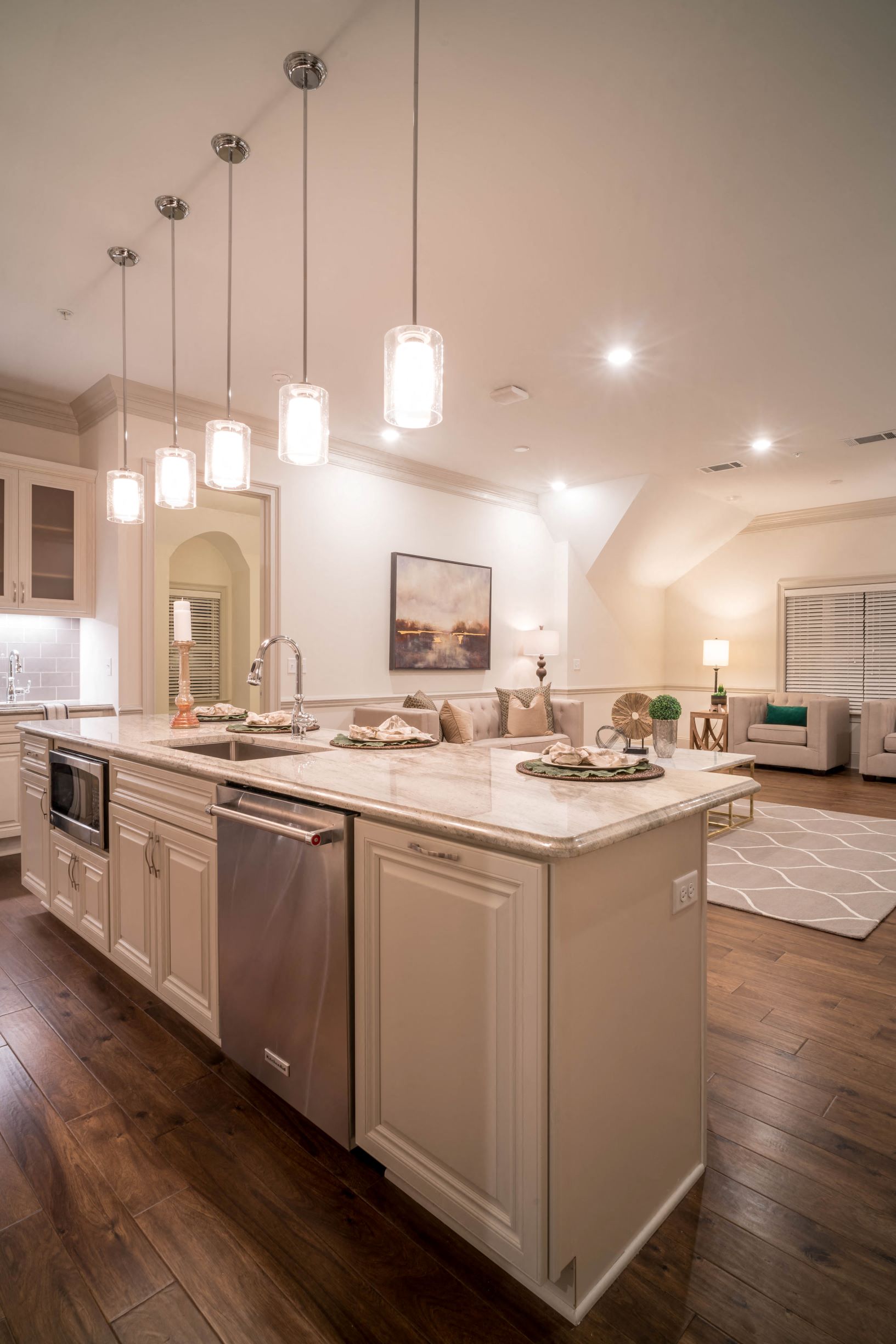 a large kitchen with a center island and a living room