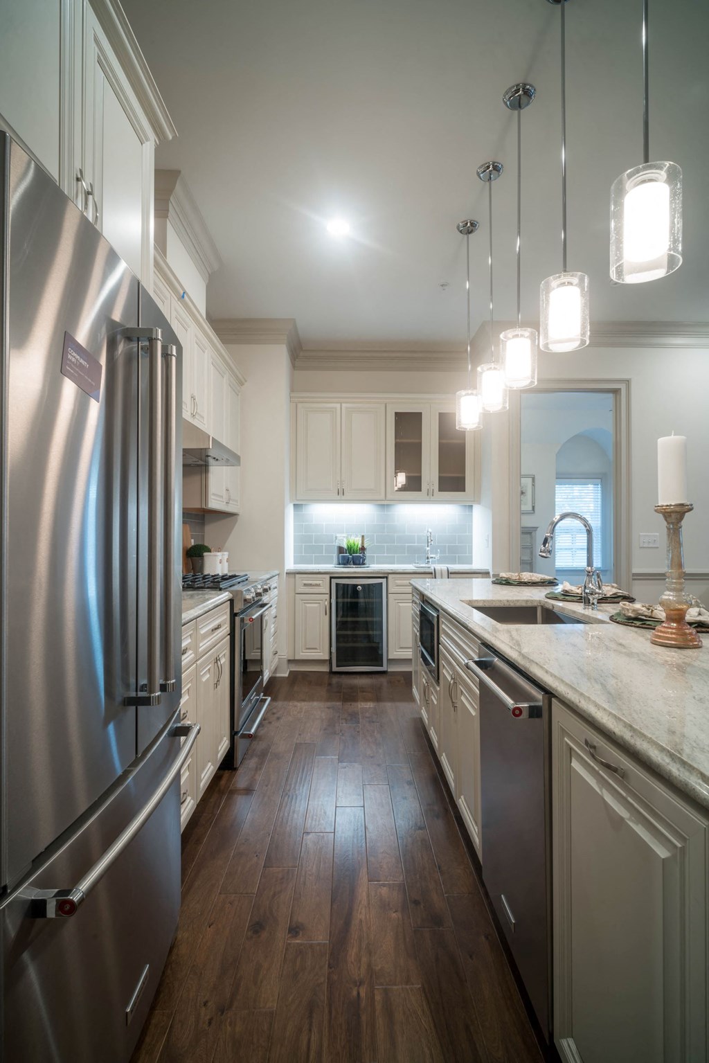 a large kitchen with white cabinets and stainless steel appliances