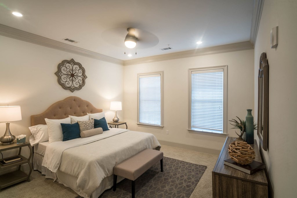 a luxurious bedroom with a large bed and two windows