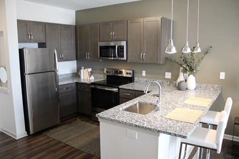 a kitchen with granite counter tops and stainless steel appliances