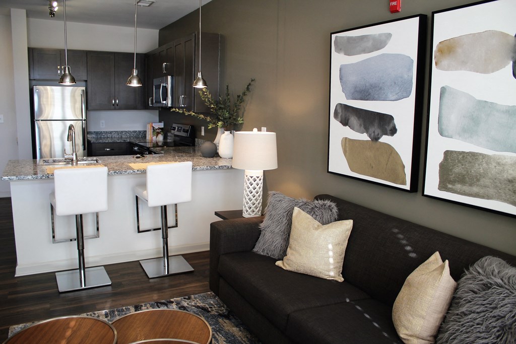 a living room with a couch and a kitchen