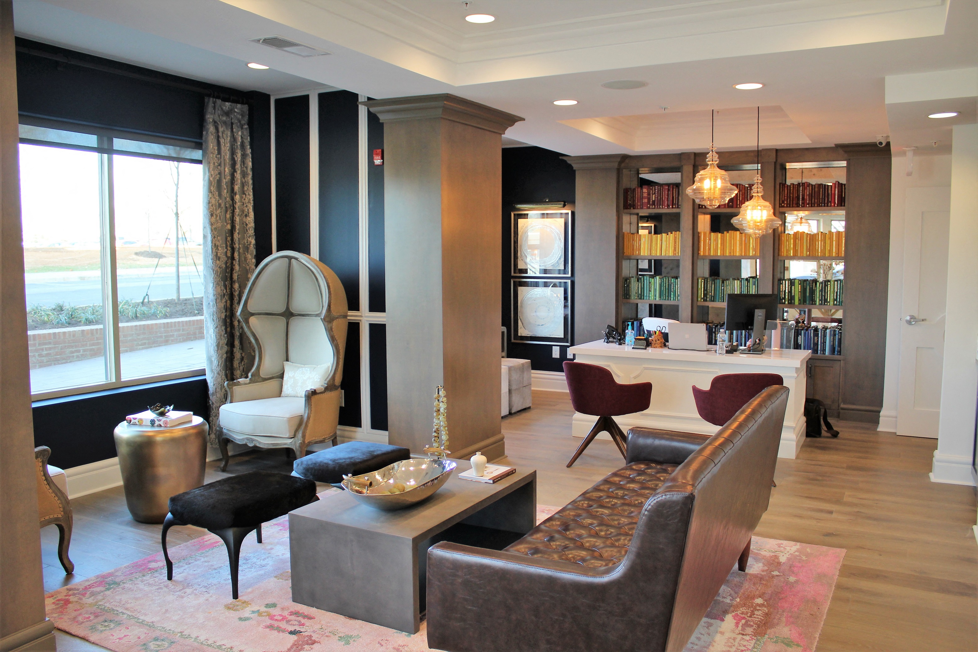 a living room filled with furniture and a bar