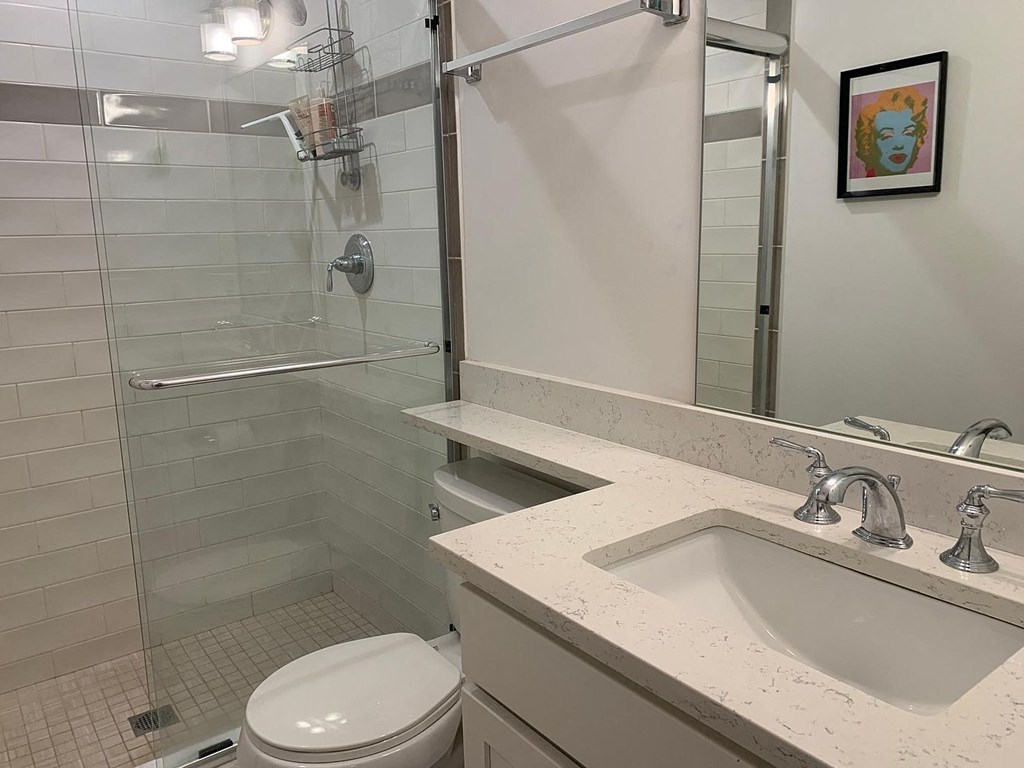 a bathroom with a sink toilet and a shower