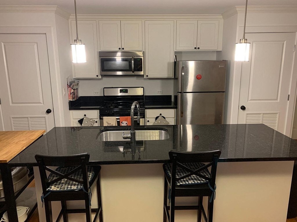 a kitchen with a counter top and a refrigerator