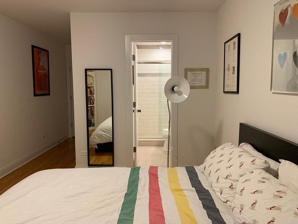 a bedroom with a bed and a door to a bathroom