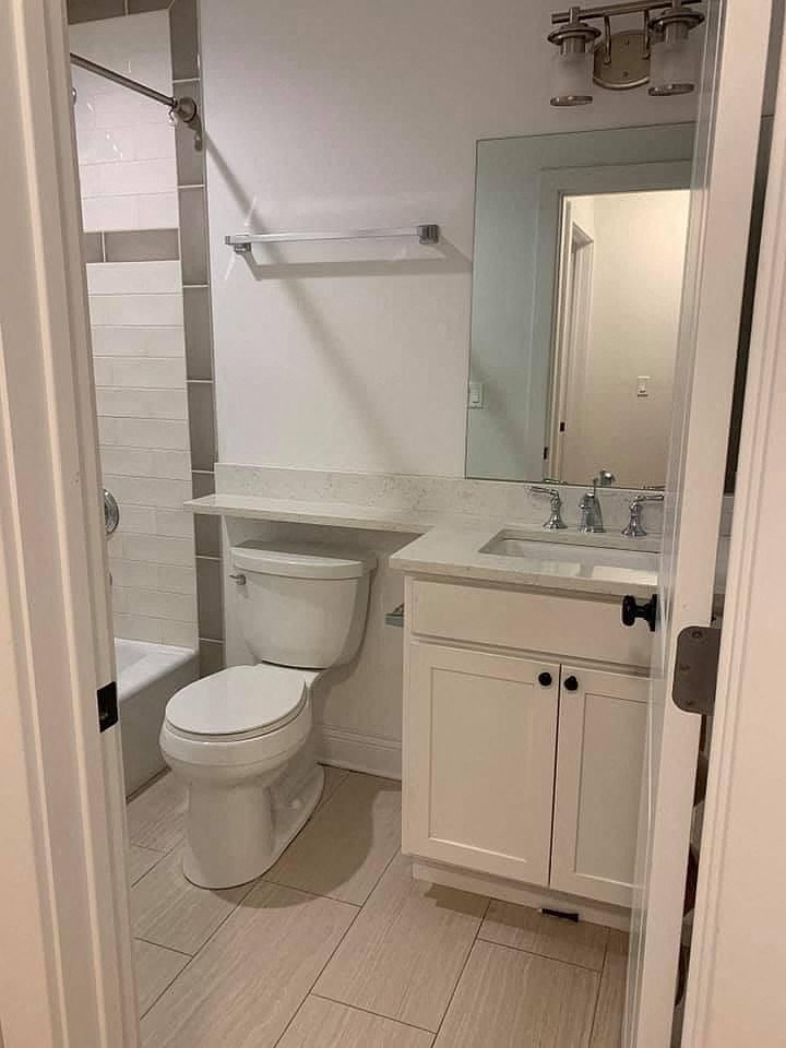 a white bathroom with a toilet and a sink