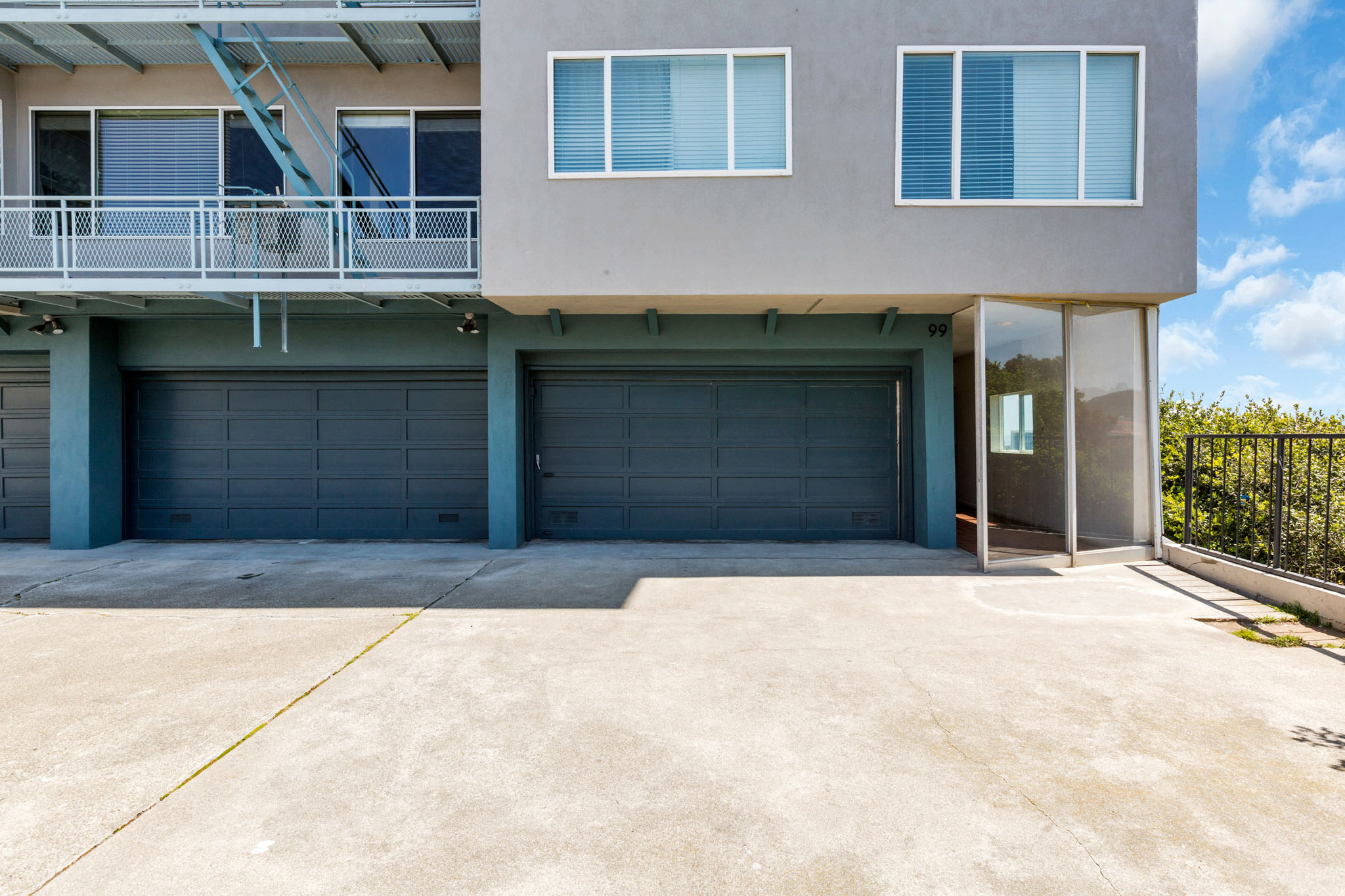 A two-story house with a garage and a balcony.