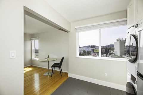 A kitchen with a table and a chair in it.