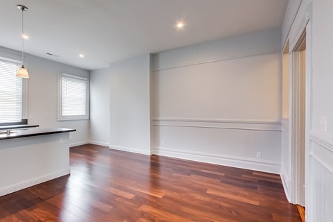 A room with wooden floors and white walls.