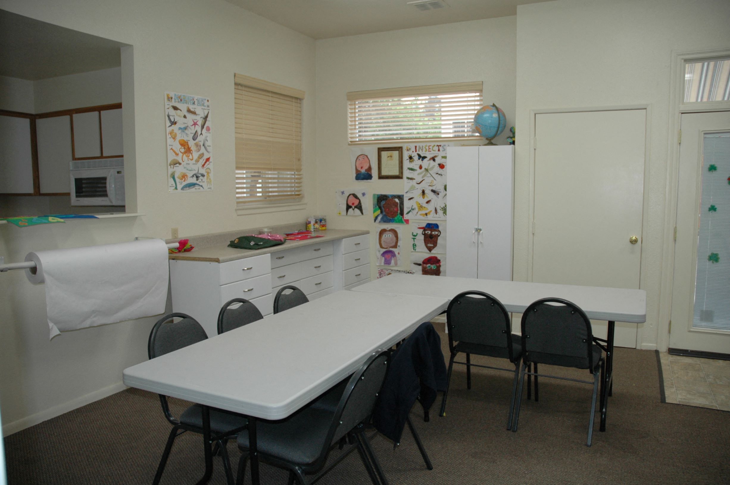 a dining room with a white table and chairs