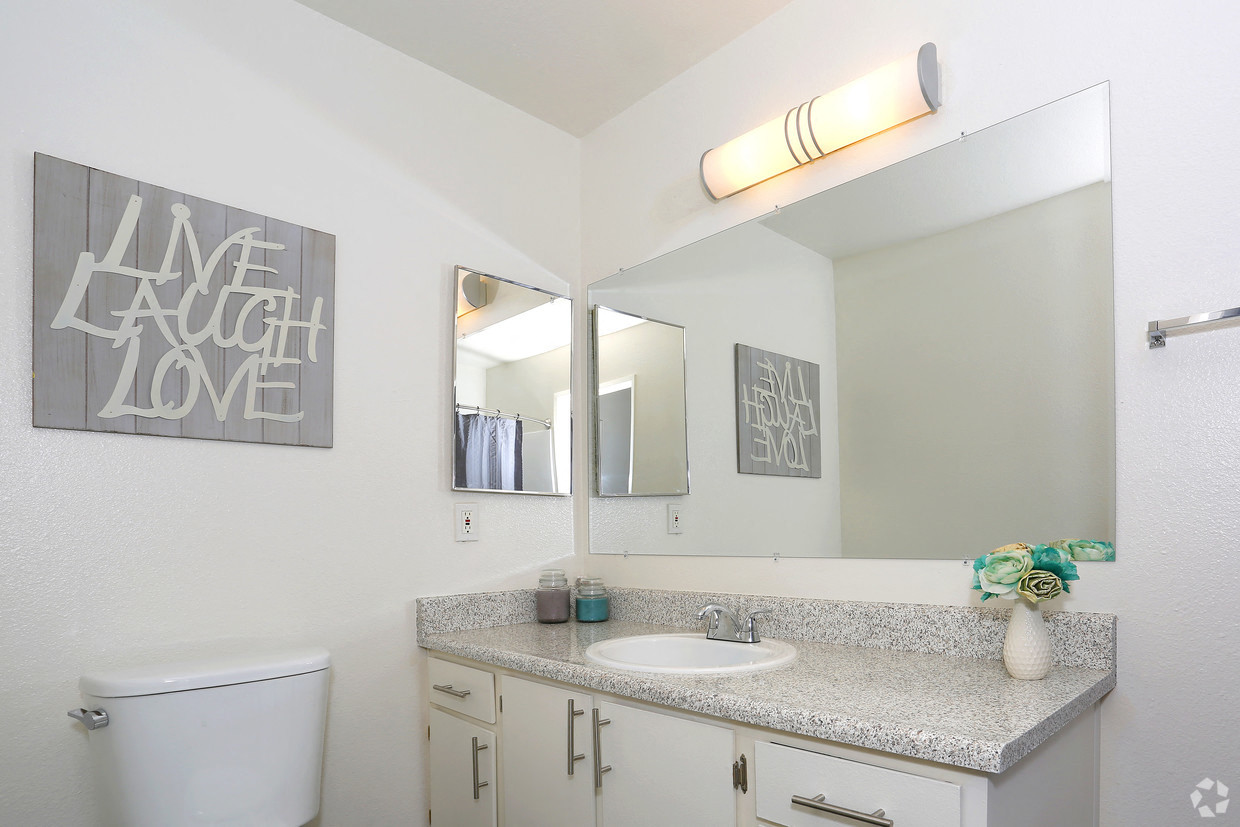 Main Bathroom displaying white theme and mirrored walls