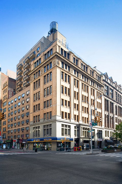 a tall building on the corner of a city street