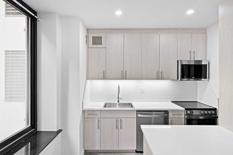 a kitchen with white counter tops and wooden cabinets
