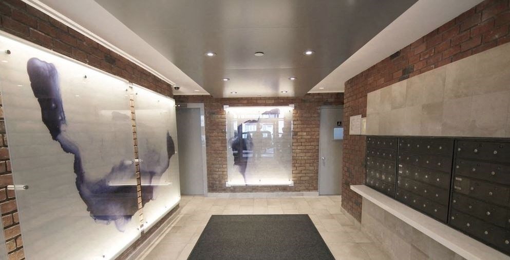 a room with a wall with a painting of a person and a door