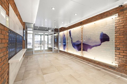 the lobby of a building with a mural on the wall