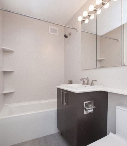 a white bathroom with a sink and a mirror