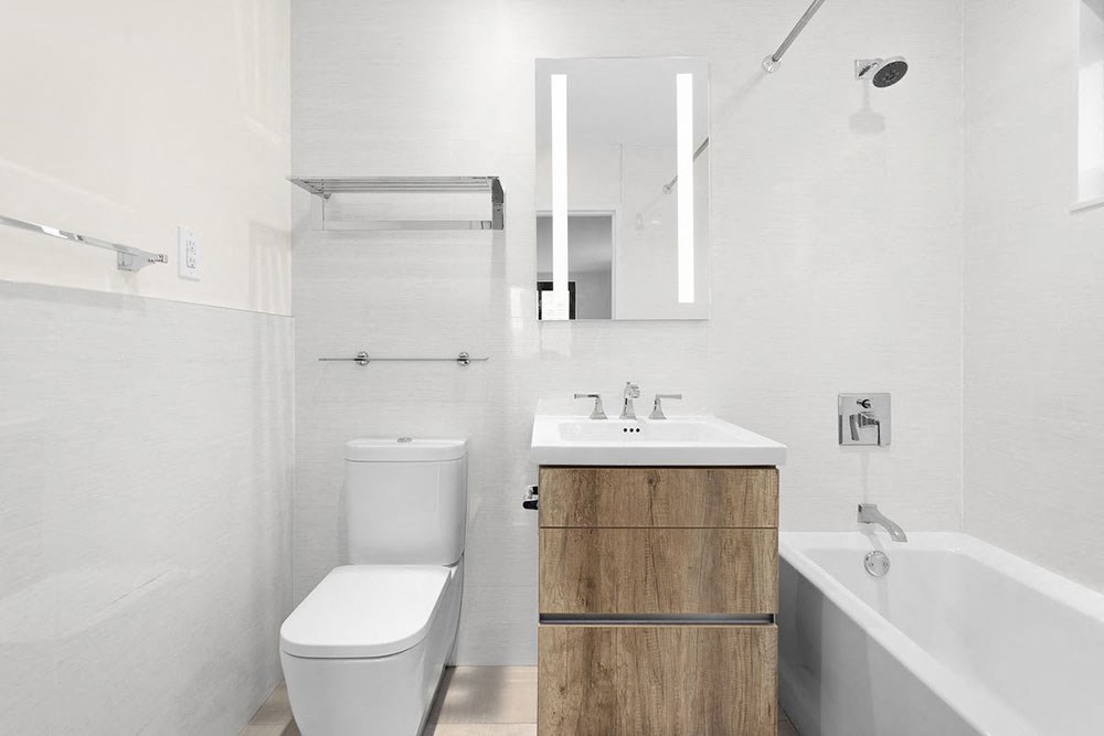 a white bathroom with a toilet and a sink