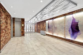 the lobby of a building with a large mural on the wall