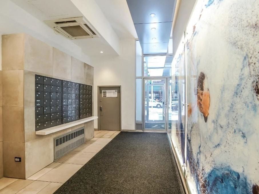 the lobby of a building with a door and a marble wall