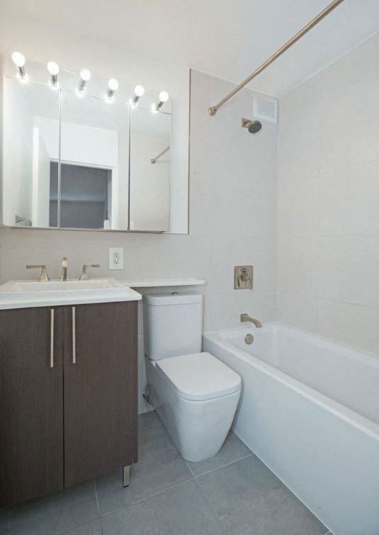 a bathroom with a toilet and a sink and a bath tub