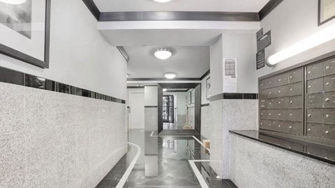 the lobby of a building with lockers and a door