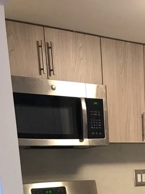 a kitchen with stainless steel appliances and wooden cabinets