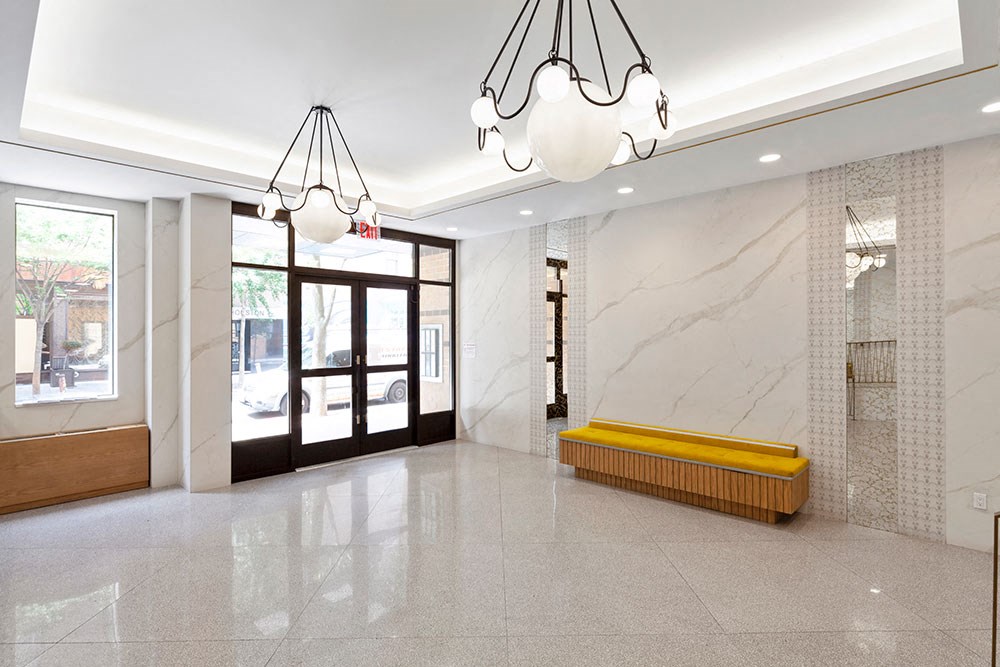 a large lobby with a yellow bench in the middle of it