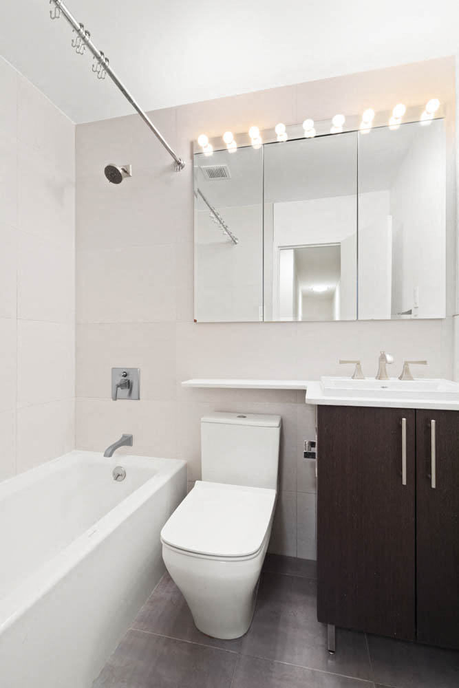 a bathroom with a toilet and a sink and a mirror