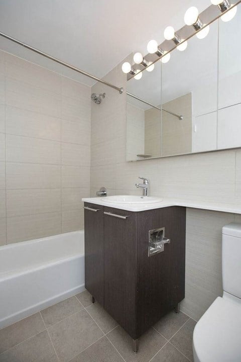 a bathroom with a sink and a toilet and a mirror