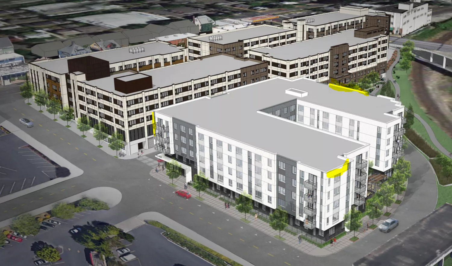 an aerial view of a city street with buildings and cars