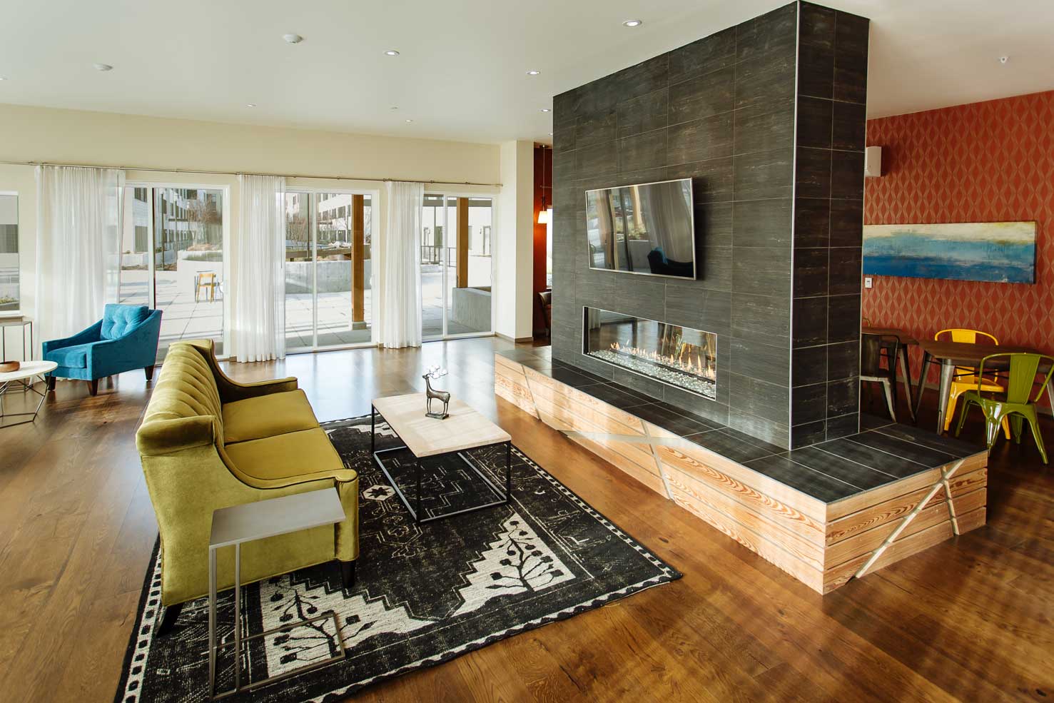 a large living room with a yellow couch and a fireplace