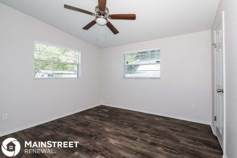 a room with a ceiling fan and a window