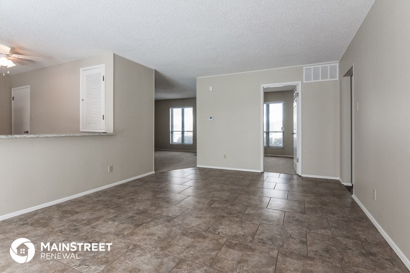 the living room and dining room of an apartment