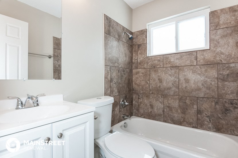 a bathroom with a sink toilet and a bath tub
