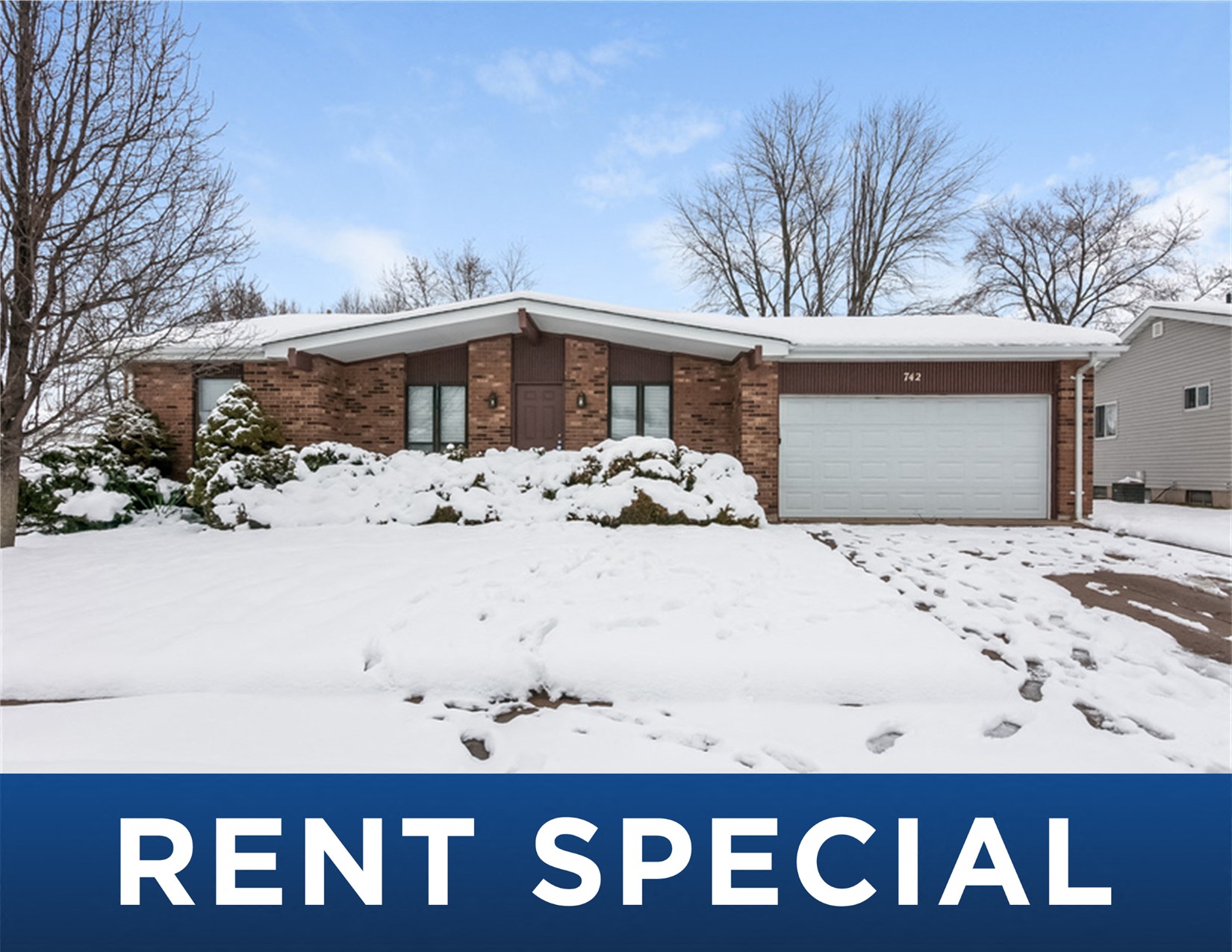 a house covered in snow with the rent special sign