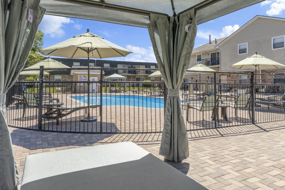 a view of a swimming pool with umbrellas and tables