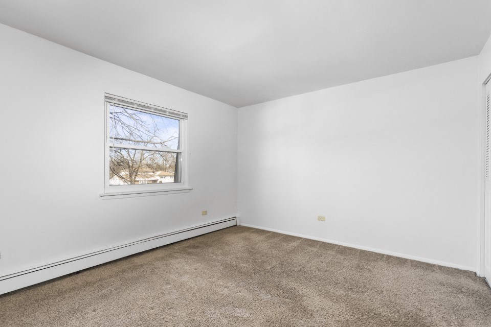 a room with carpet and a window in it