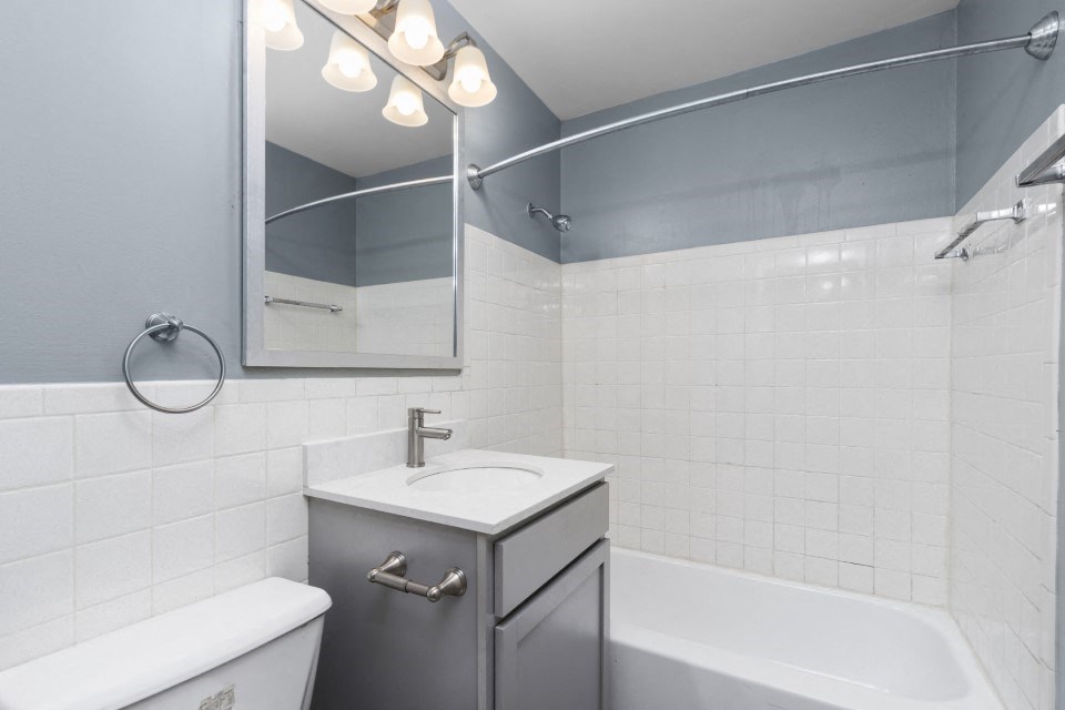 a bathroom with a sink and a tub and a mirror