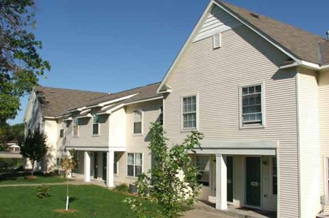 a row of houses with trees in front of them