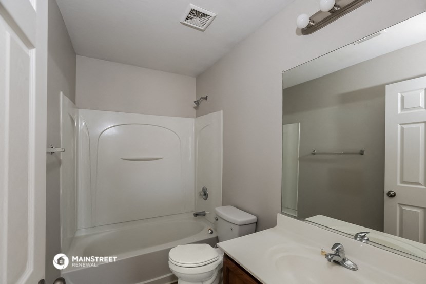 a bathroom with a sink and a toilet and a bath tub