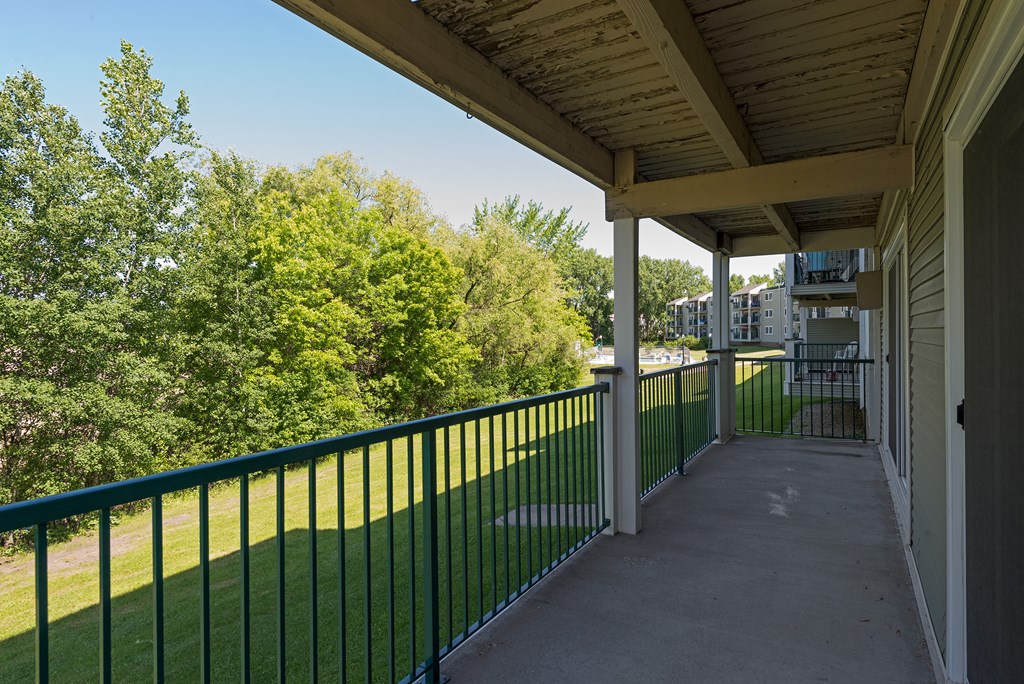 a view of the balcony with trees in the background