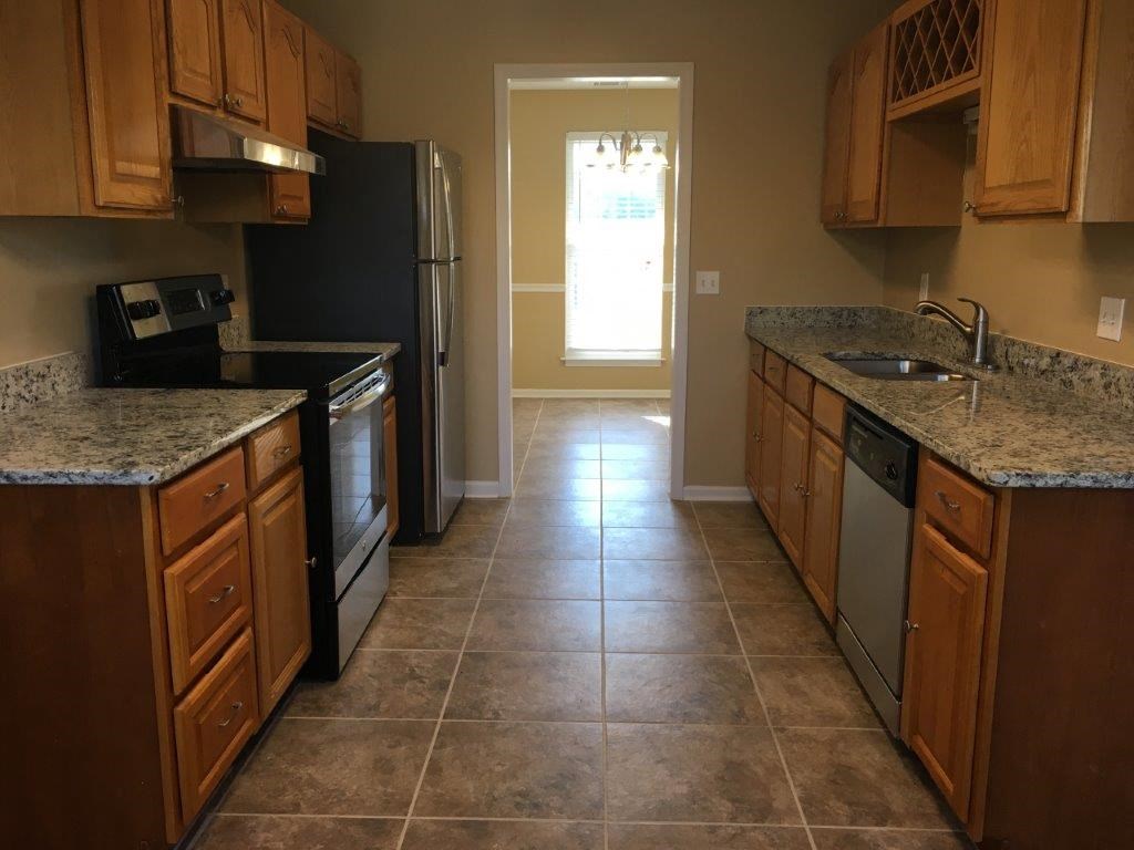 a kitchen with a sink and a refrigerator