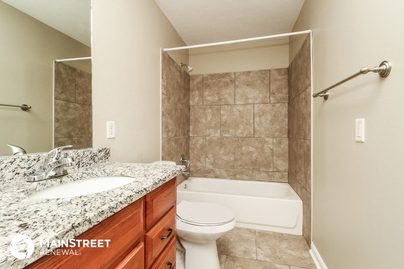 a bathroom with a sink and a toilet and a tub