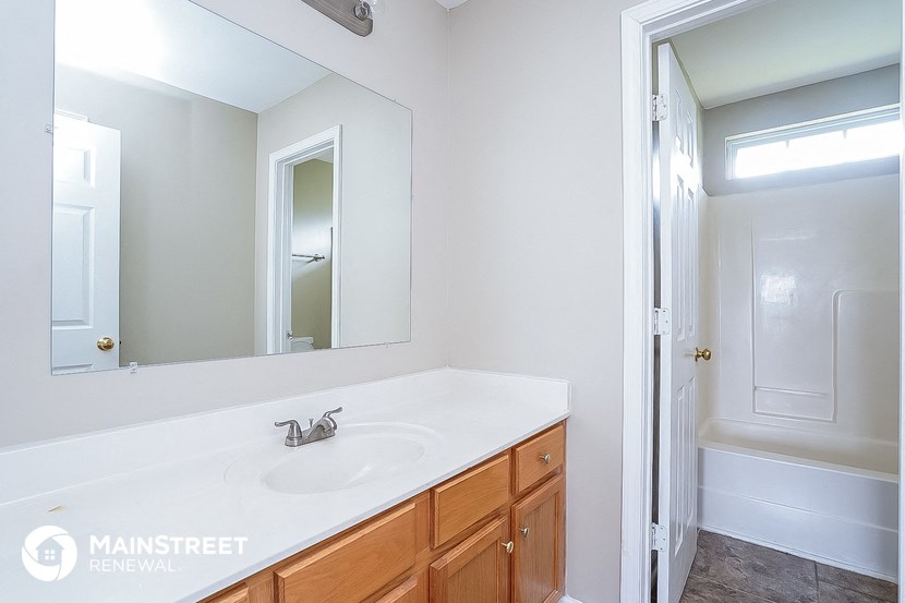 a bathroom with a sink and a mirror and a shower