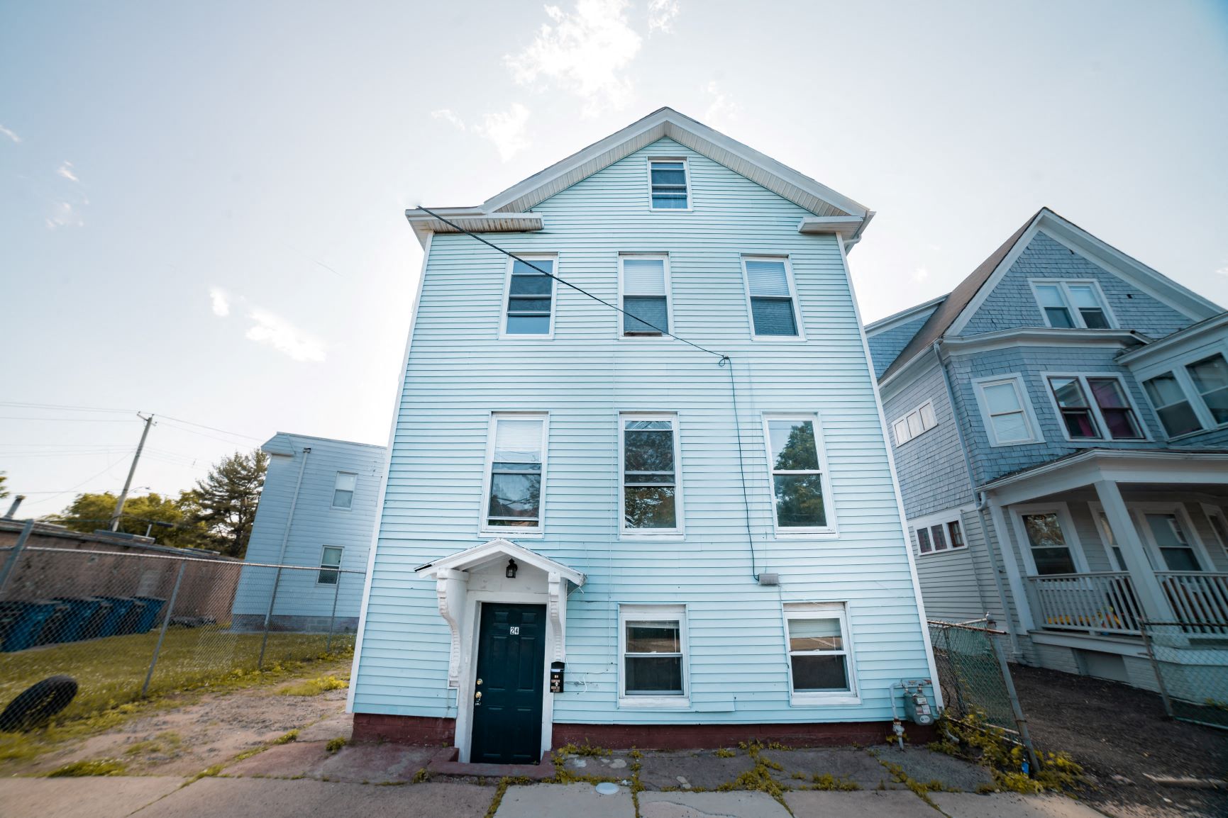 A white house with a black door and windows.
