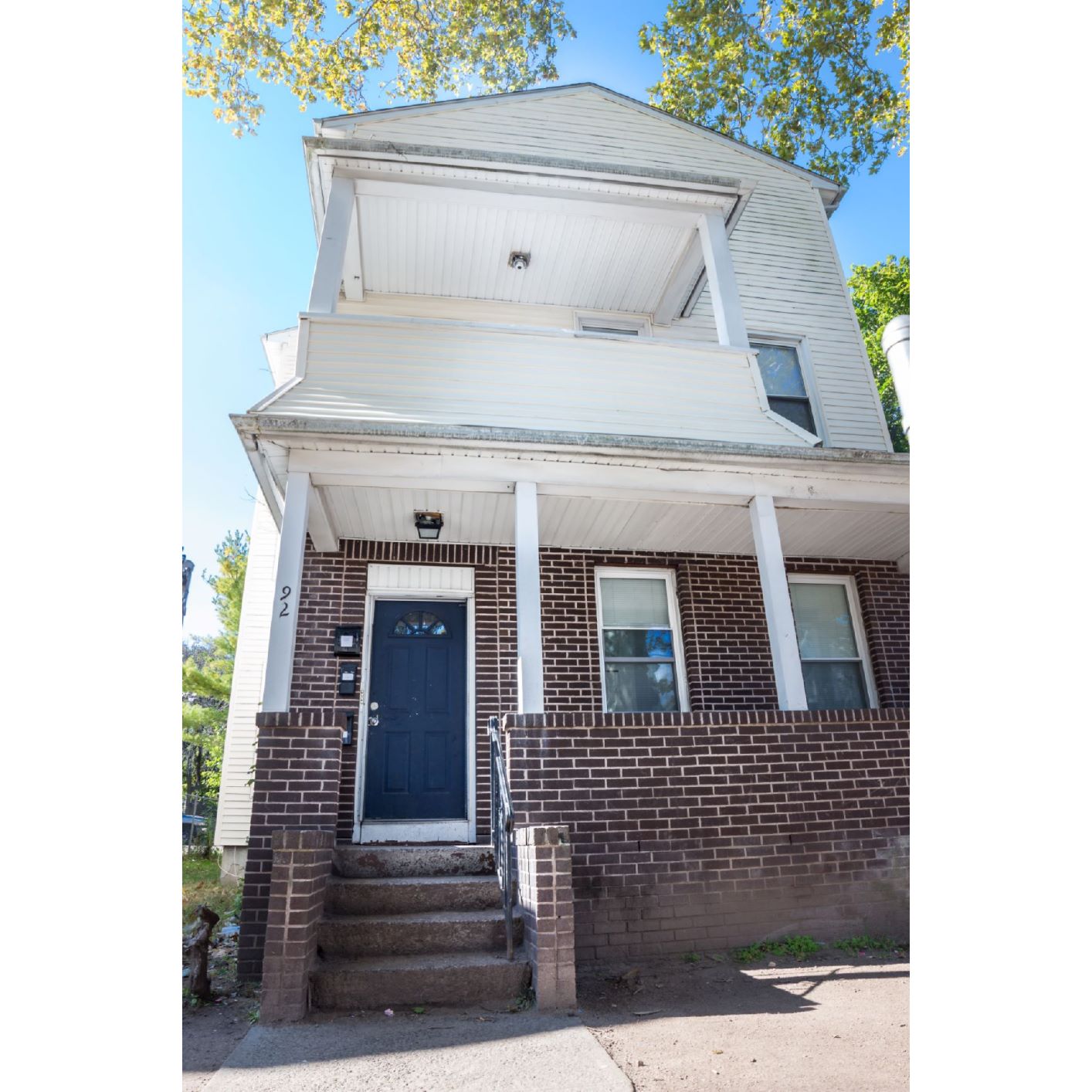 A house with a blue door and a white porch.